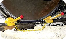 Double railroad wheel chock for exposed rail